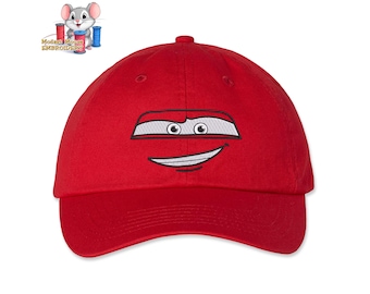 May include: Red baseball cap with an embroidered image of Lightning McQueen from the Cars movie. The embroidery shows McQueen's face with a big smile.