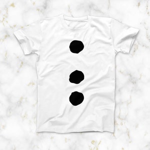 May include: White t-shirt with three black circles on the front.
