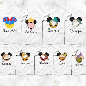 May include: Set of ten white t-shirts featuring Disney's Snow White and the Seven Dwarfs. Each shirt has a different character's face with their name printed below. The characters are Snow White, Evil Queen, Bashful, Sleepy, Sneezy, Happy, Grumpy, Doc, and Dopey.