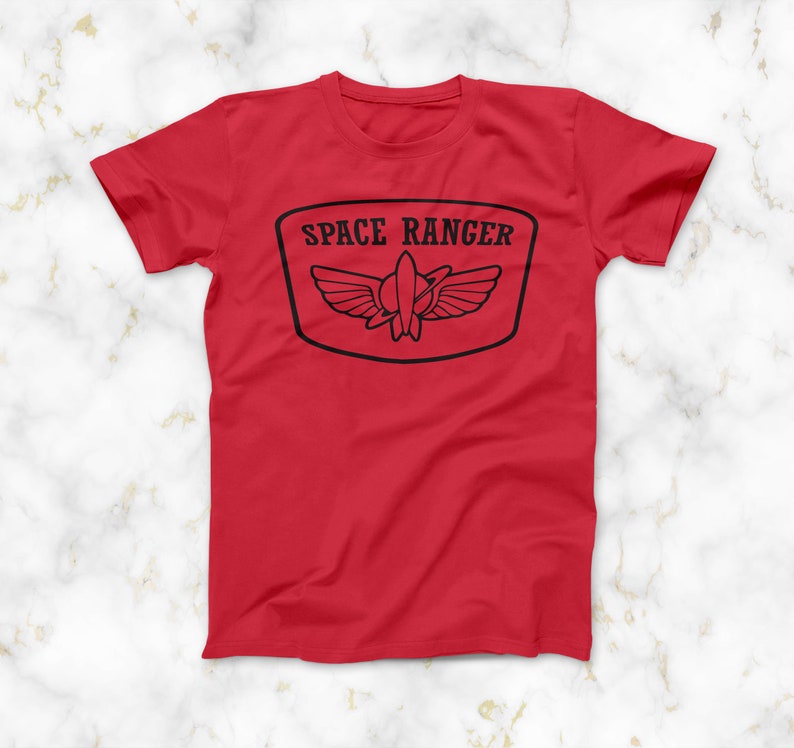 May include: Red t-shirt with a black graphic of a space ranger badge with the text "SPACE RANGER" on it.