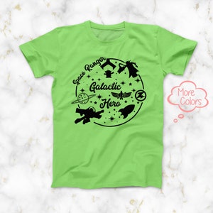 May include: A green t-shirt with a black graphic design featuring a spaceship, planets, stars, and the text "Space Ranger Galactic Hero".