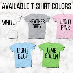 May include: Five t-shirts in different colors, showing the available colors for purchase. The colors are white, heather grey, light pink, light blue, and lime green.