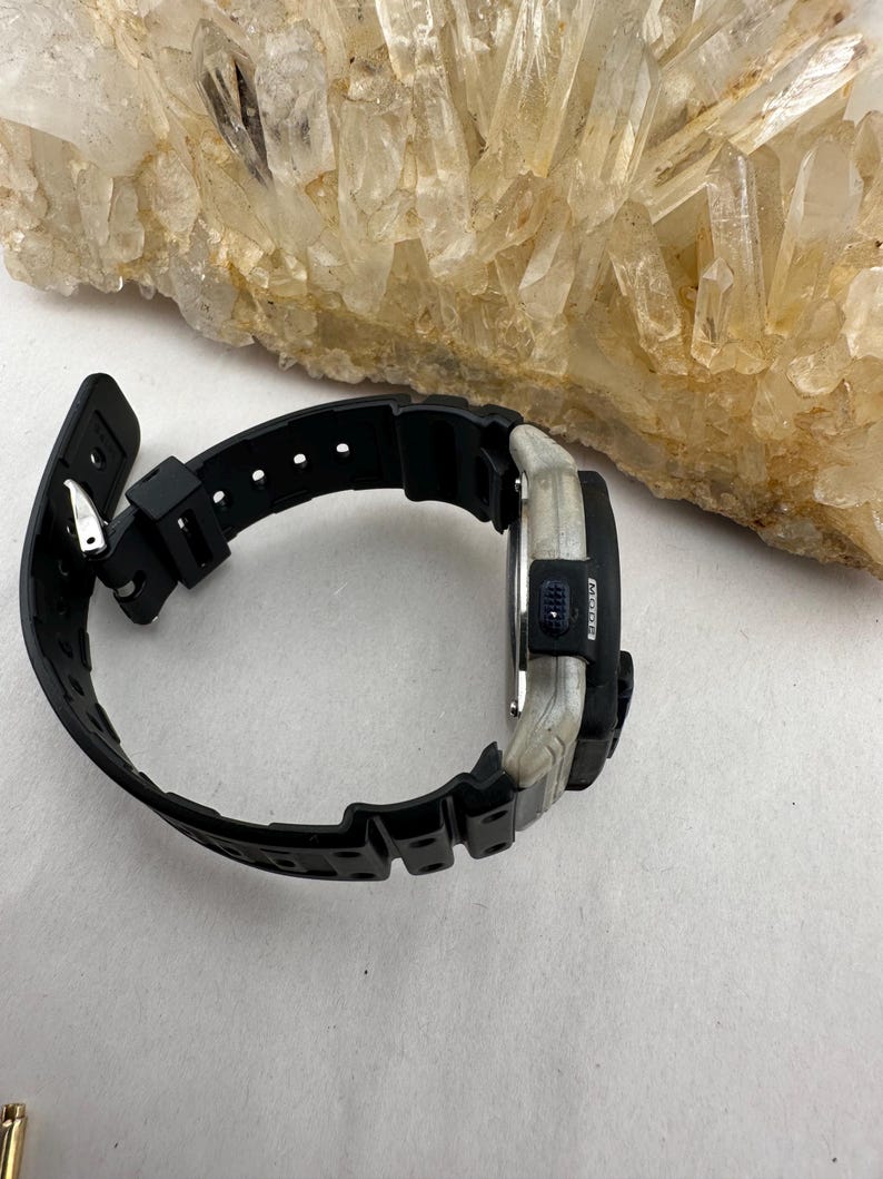 May include: A set of three ceramic mugs with a speckled, matte finish. The mugs are in shades of cream, light gray, and dark gray. Each mug has a simple, minimalist design and a rounded handle. The mugs are stacked on top of each other.