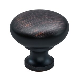 Puede incluir: Un pomo de mueble redondo con acabado en bronce oscuro frotado con aceite, con sutiles reflejos cobrizos en la superficie cepillada. El herraje presenta una parte superior lisa y abovedada y una base cónica que conecta con una placa circular.