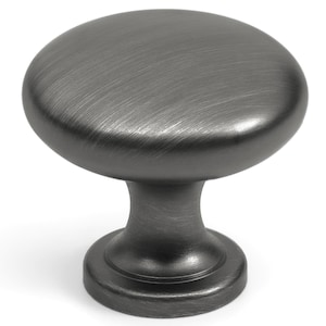 May include: A round cabinet knob with a dark gray, brushed metallic finish. The knob features a smooth, domed top surface and a tapered cylindrical base that flares out at the bottom, creating a simple, functional hardware piece for furniture.