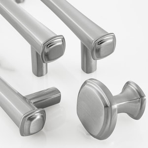 May include: A collection of brushed silver cabinet hardware including three elongated bar pulls with square end caps and one circular knob. Each piece features a smooth, metallic finish with a consistent design, showcasing a clean, functional aesthetic.