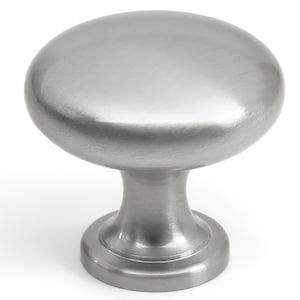 May include: A brushed nickel cabinet knob with an oval top and a cylindrical base. The hardware has a smooth, metallic finish and is designed for easy installation on drawers and cabinets.