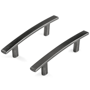 May include: Two dark gray metal cabinet pulls with a brushed finish. Each handle features a slightly arched bar design supported by two cylindrical posts, providing a sleek and functional hardware component for drawers or cabinet doors.
