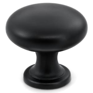 May include: A matte black cabinet knob featuring a smooth, rounded mushroom-shaped head and a tapered cylindrical base. The hardware has a solid, uniform dark finish with a wide circular mounting plate at the bottom for secure attachment.