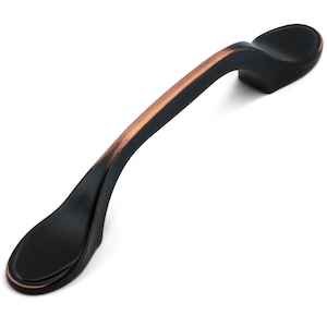 May include: A curved cabinet pull handle featuring a matte black finish with copper-toned highlights along the top edge. The hardware has a smooth, elongated arch shape with rounded ends and two mounting points for attachment to furniture or doors.