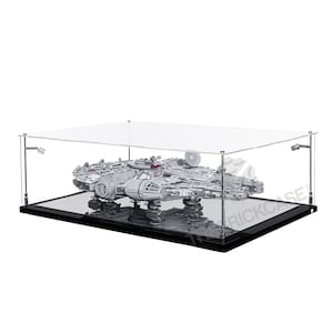 May include: A clear acrylic display case with a black base, showcasing a detailed model of the Millennium Falcon spaceship. The case is designed to protect and display the model.