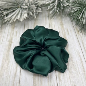 May include: A dark green satin scrunchie for hair.