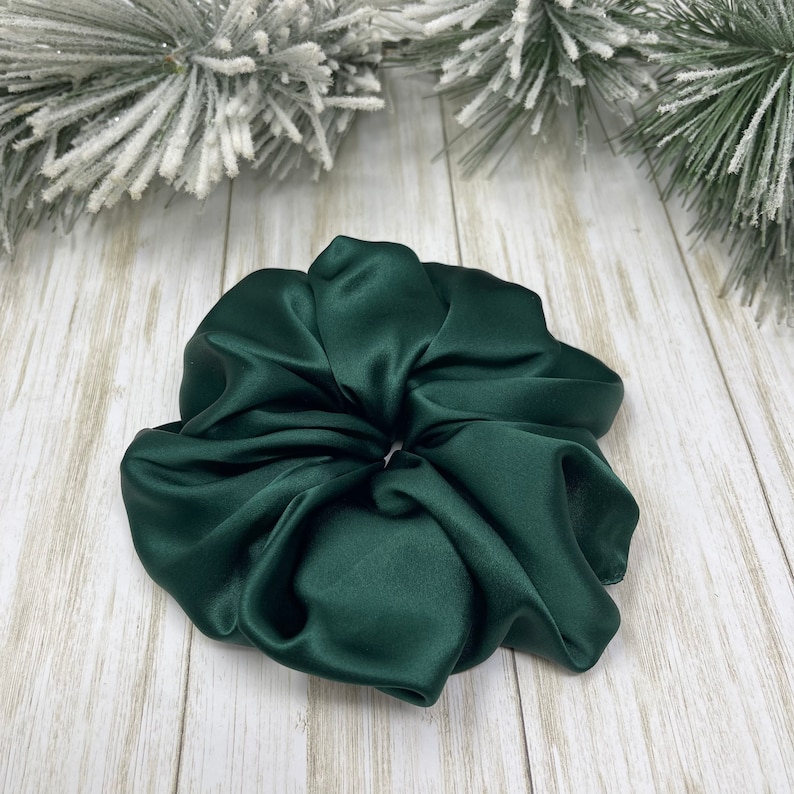 May include: A dark green satin scrunchie for hair.