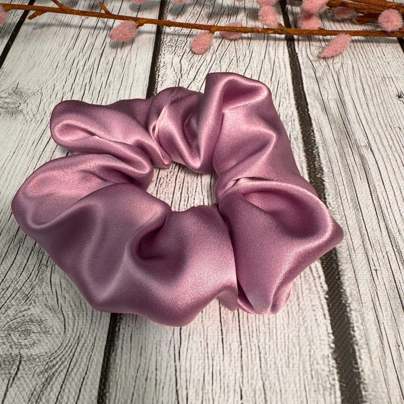 May include: A dusty rose colored satin scrunchie for hair.