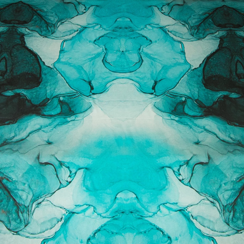 May include: Abstract art print featuring swirling blue and green ink, creating a symmetrical design.
