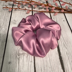 May include: A dusty rose satin scrunchie for hair.