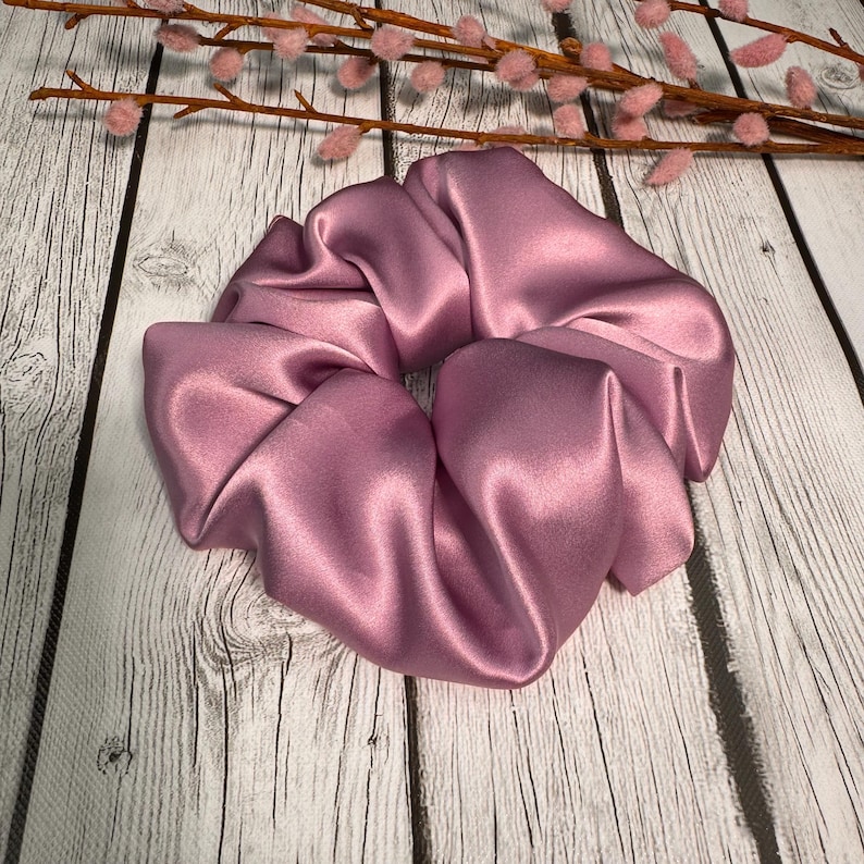 May include: A dusty rose satin scrunchie for hair.