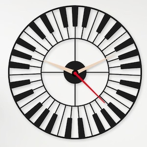May include: A black and white wall clock with a piano key design. The clock face is white with black hands and a red second hand. The clock is round and has a diameter of approximately 12 inches.