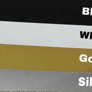 May include: Four swatches of fabric in different colors: black, white, gold, and silver.