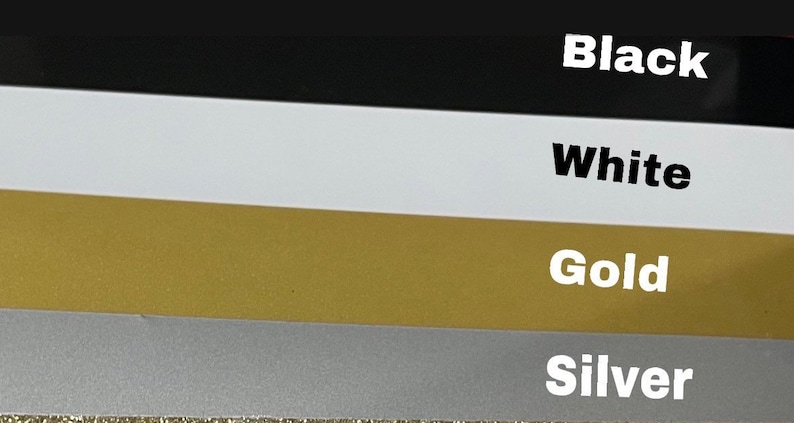 May include: Four swatches of fabric in different colors: black, white, gold, and silver.