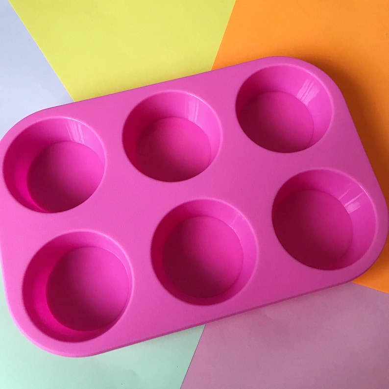May include: Pink silicone baking mould with six round cavities.
