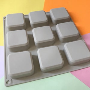 May include: Gray silicone mold with nine square cavities for making soap or resin crafts.