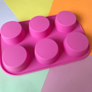 May include: Pink silicone mould with six round cavities for making soap, candles, or other crafts.
