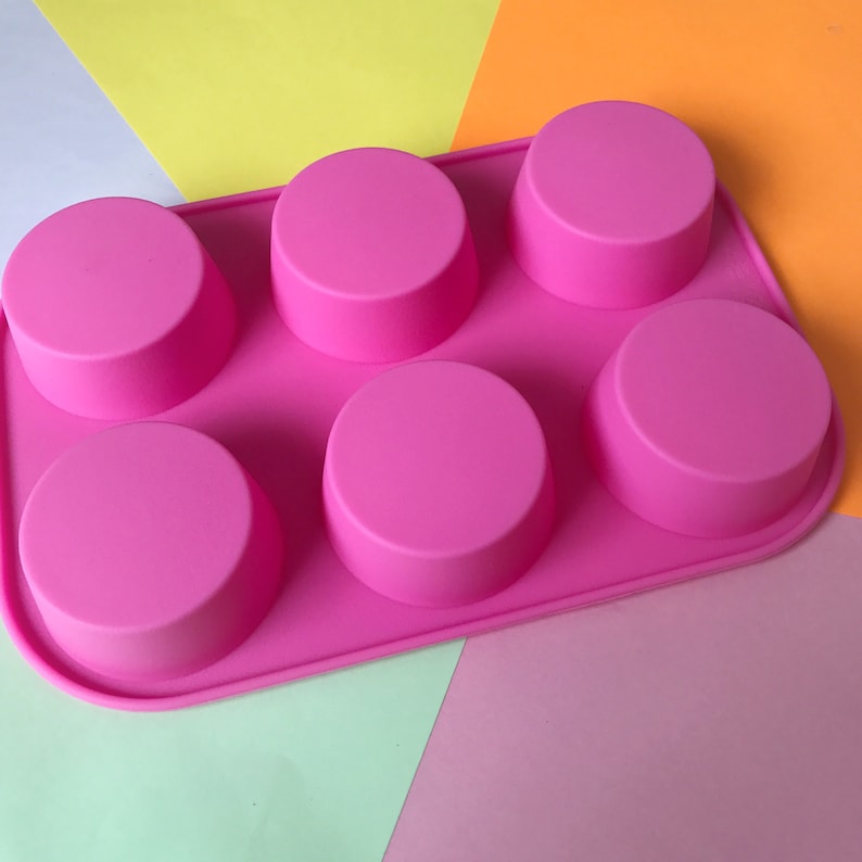 May include: Pink silicone mould with six round cavities for making soap, candles, or other crafts.