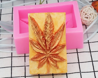 May include: A pink silicone mould with a detailed golden leaf design. The mould is perfect for making decorative soap, resin, or chocolate.