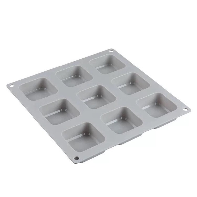 May include: A gray silicone baking mold with nine square cavities. The mold is designed for making small cakes, pastries, or other treats.