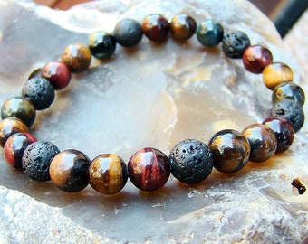 May include: A beaded bracelet with brown, red, and black beads. The beads are made of tiger's eye, red jasper, and lava rock.