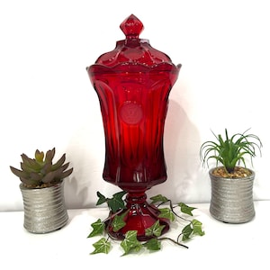 May include: A rustic wooden sign with the text "Welcome to our home" in white lettering. The sign features a distressed finish and a simple, inviting design, perfect for entryway decor.