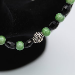 Hand-Crafted Stretch band Black oblong with green wonder glow glass beads with silver medallion bracelet
