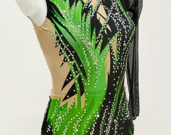 May include: A black and green leotard with a long sleeve made of sheer black mesh. The leotard has a geometric design with green and black accents and rhinestones.