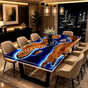 May include: A rectangular dining table featuring a natural wood slab with a live edge and a central river design made of glowing blue resin. The table is supported by a black metal frame and is surrounded by six beige upholstered dining chairs.