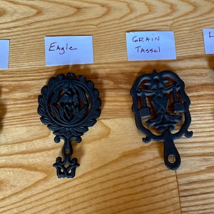 Vintage 5&quot; Cast Iron Trivets: Tree, Eagle, Love Birds, Grain Tassel Motifs