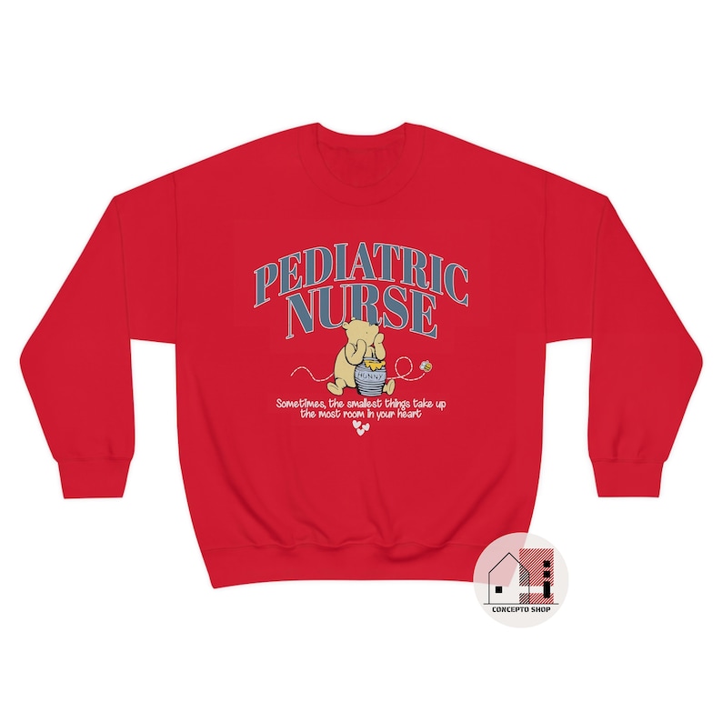 May include: Red sweatshirt with a Winnie the Pooh illustration and the text "Pediatric Nurse" in blue and white. The text below the illustration reads "Sometimes, the smallest things take up the most room in your heart."