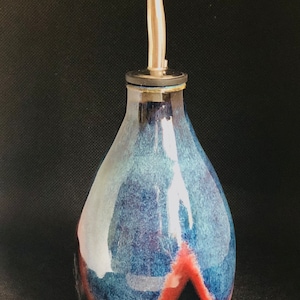 Handmade ceramic oil bottle in a black, blue and green glaze