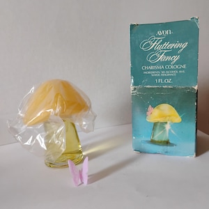 May include: A vintage Avon "Fluttering Fancy" Charisma Cologne bottle shaped like a mushroom with a yellow cap and clear glass body. The box is teal with the product name and a picture of the bottle. A small pink butterfly is in front of the bottle.