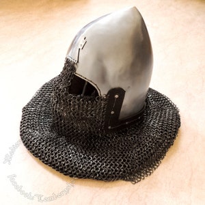 May include: A pointed, silver helmet with a chainmail coif. The helmet has a leather trim and a pointed top.