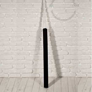 May include: A black wooden staff with a white tip. The staff is about 1.5 meters long. The staff is standing upright against a white brick wall. The text "Medieval Armor & Craft" is visible in the upper right corner of the image. The text "www.medievalarmour.eu" is visible in the lower right corner of the image.