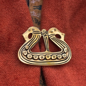 Drakkar longship Viking fibula. Reenactment pin 800-1050 AD. The original brooch was found on the island of Fyn, Denmark.