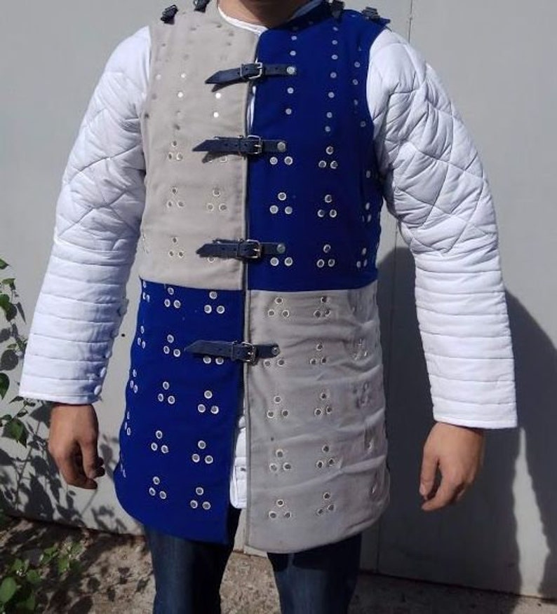 May include: A blue and grey padded vest with a quilted design and metal accents. The vest has a front closure with straps and buckles.