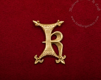 The letter K Medieval badge replica. Pilgrim pin for a hat or a cloak, for Renaissance costume at the end 14th century.