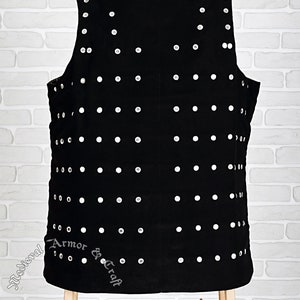 May include: Black leather vest with silver studs, featuring the text "Medieval Armor & Craft" and the website address "www.medievalarmour.eu".