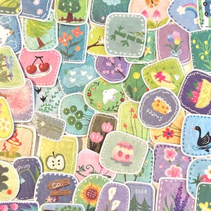 May include: A collection of small, rectangular stickers with rounded corners, each featuring unique hand-painted illustrations of nature, animals, fruits, and flowers, including a black swan, a jar of jam, a sunflower, and text like "sweet" and "tree."