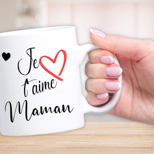 May include: White ceramic mug with black text that reads "Je t'aime Maman" with a red heart.
