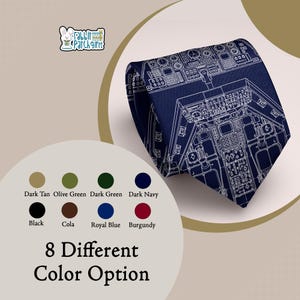 May include: A dark navy necktie featuring a white line-art print of an airplane cockpit instrument panel. The design includes various gauges, switches, and dials. The image also displays a logo with the text Rabbit Patch Gifts and a color chart.