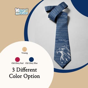 May include: A blue necktie featuring a white graphic of an eagle head and the text We the People printed repeatedly across the fabric. The tie includes small white star accents and is displayed alongside color swatches labeled Vinateg, Old Glory Red, and Old Glory Blue, with the text 3 Different Color Option.
