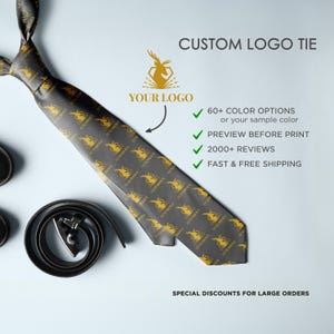May include: A black silk tie with a repeating pattern of a gold stag logo. The text "YOUR LOGO" is above the stag logo. The text "CUSTOM LOGO TIE" is at the top of the image. The text "60+ COLOUR OPTIONS or your sample colour" is below the logo. The text "PREVIEW BEFORE PRINT" is below the colour options. The text "2000+ REVIEWS" is below the preview text. The text "FAST & FREE SHIPPING" is below the reviews. The text "SPECIAL DISCOUNTS FOR LARGE ORDERS" is at the bottom of the image.